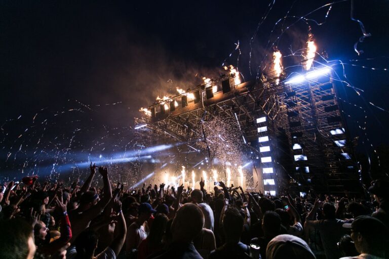 Festival crowd with stage pyrotechnics at night
