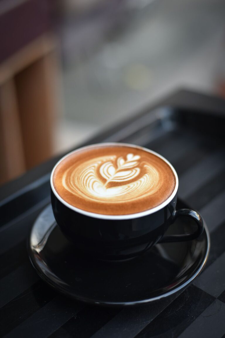 Cup of coffee with latte art in low light